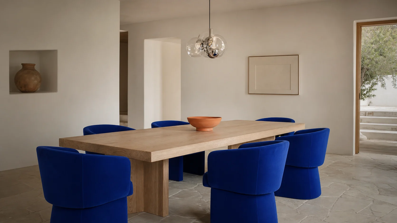 Salle à manger avec chaises bleu Klein autour d’une table claire